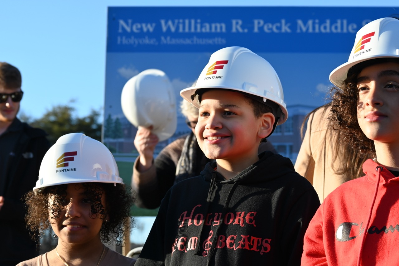 Children look excited in hard hats