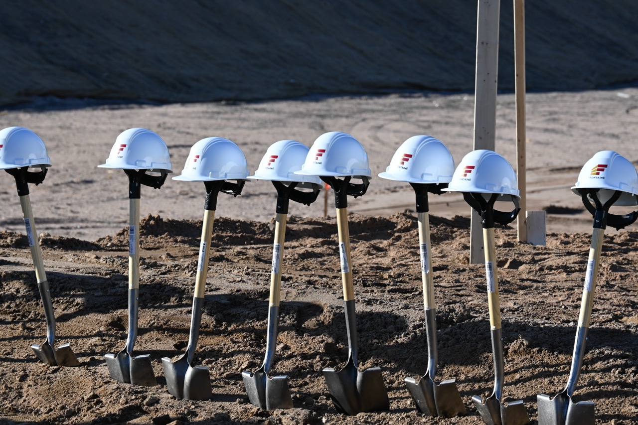 Row of shovels with hats