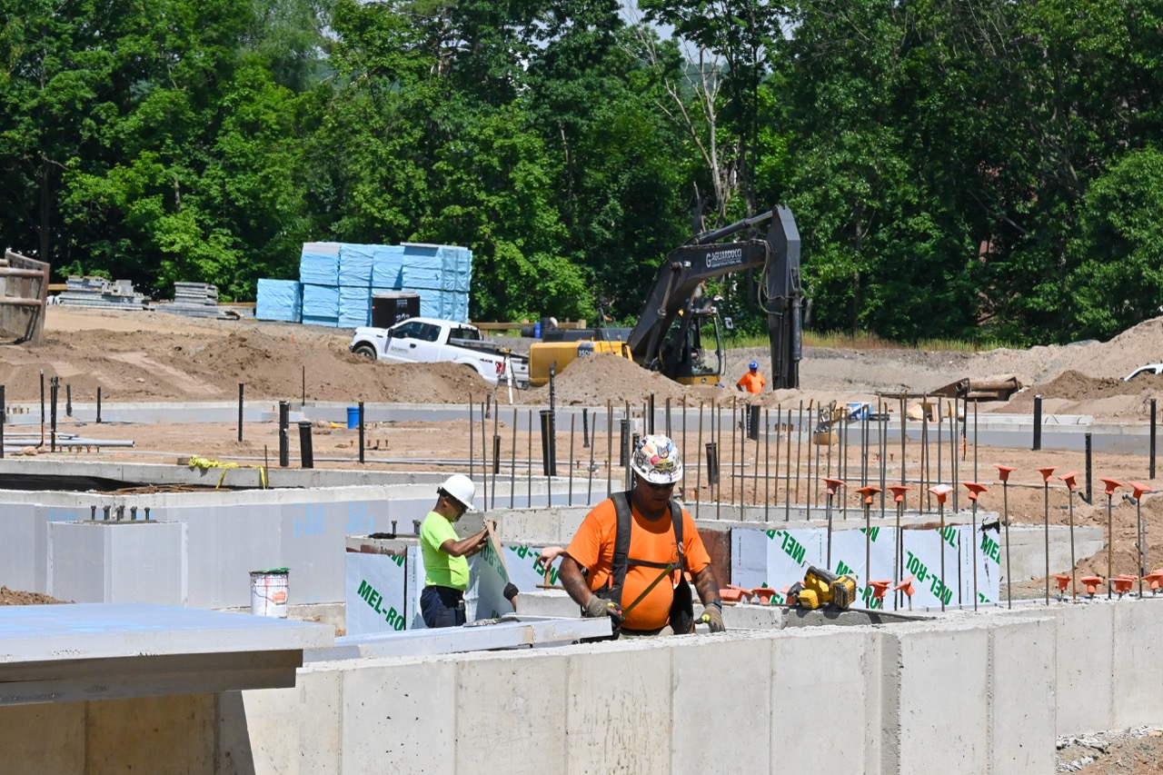 Construction workers secure the building's foundation