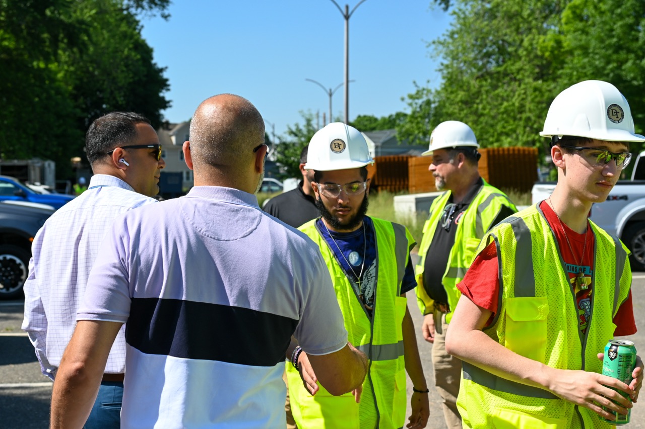 Dean students in hard hats and safety vests prepare for their tour