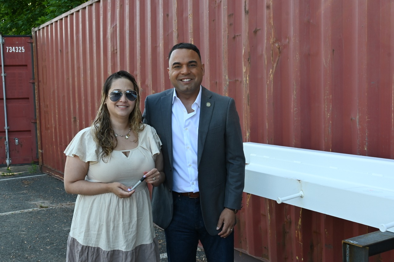 Mayor Garcia and Stefany Garcia smile after signing the beam