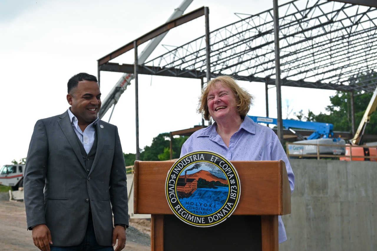 The Mayor and a guest speaker stand behind the podium