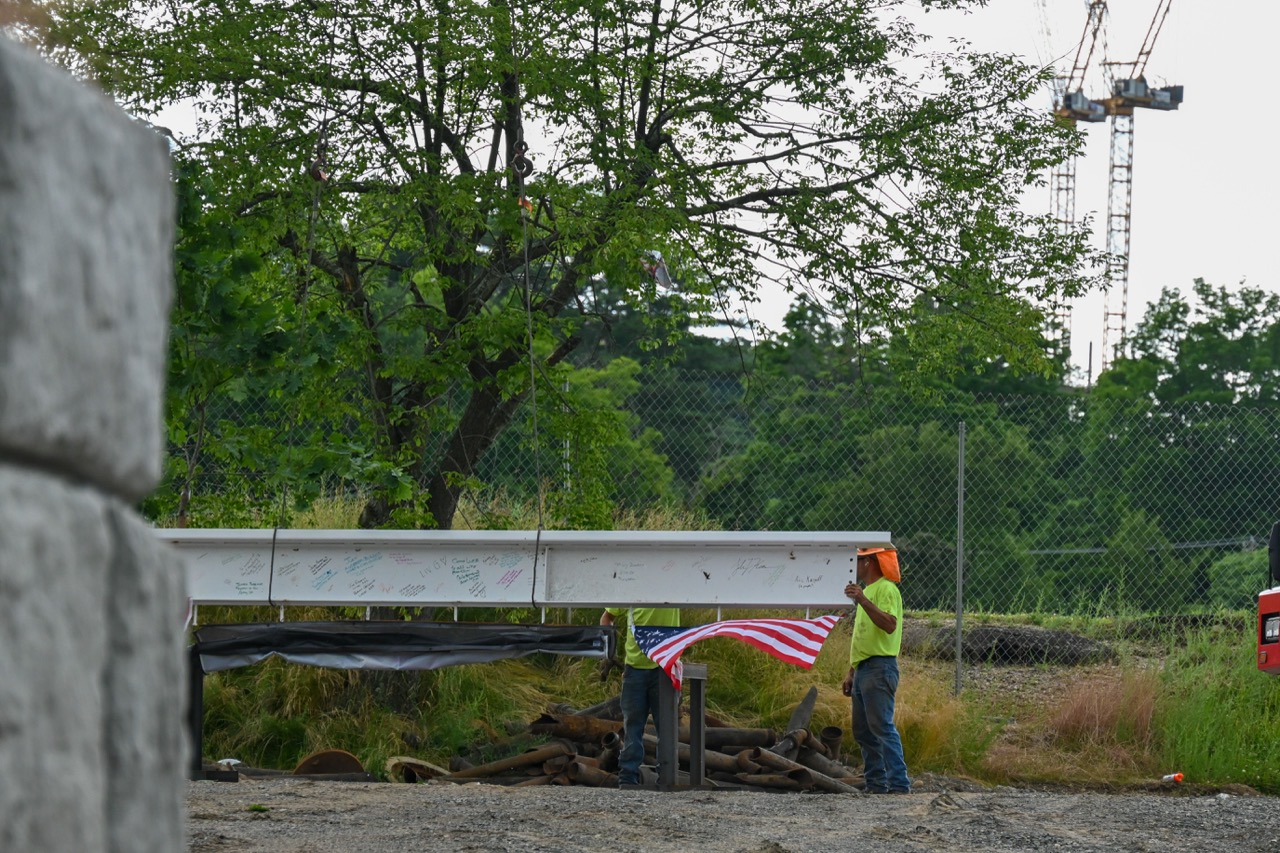 The beam waits at ground level to be lifted up