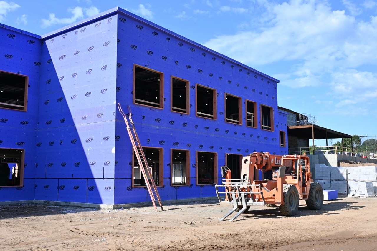 Outer wall with purple-papered sheetrock in stalled