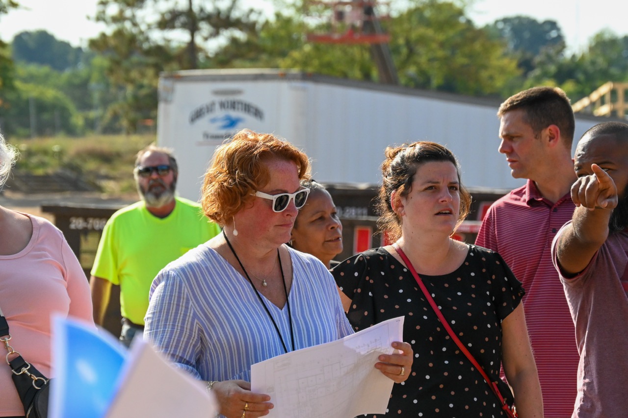 Ellie Wilson listens to a tour guide on-site