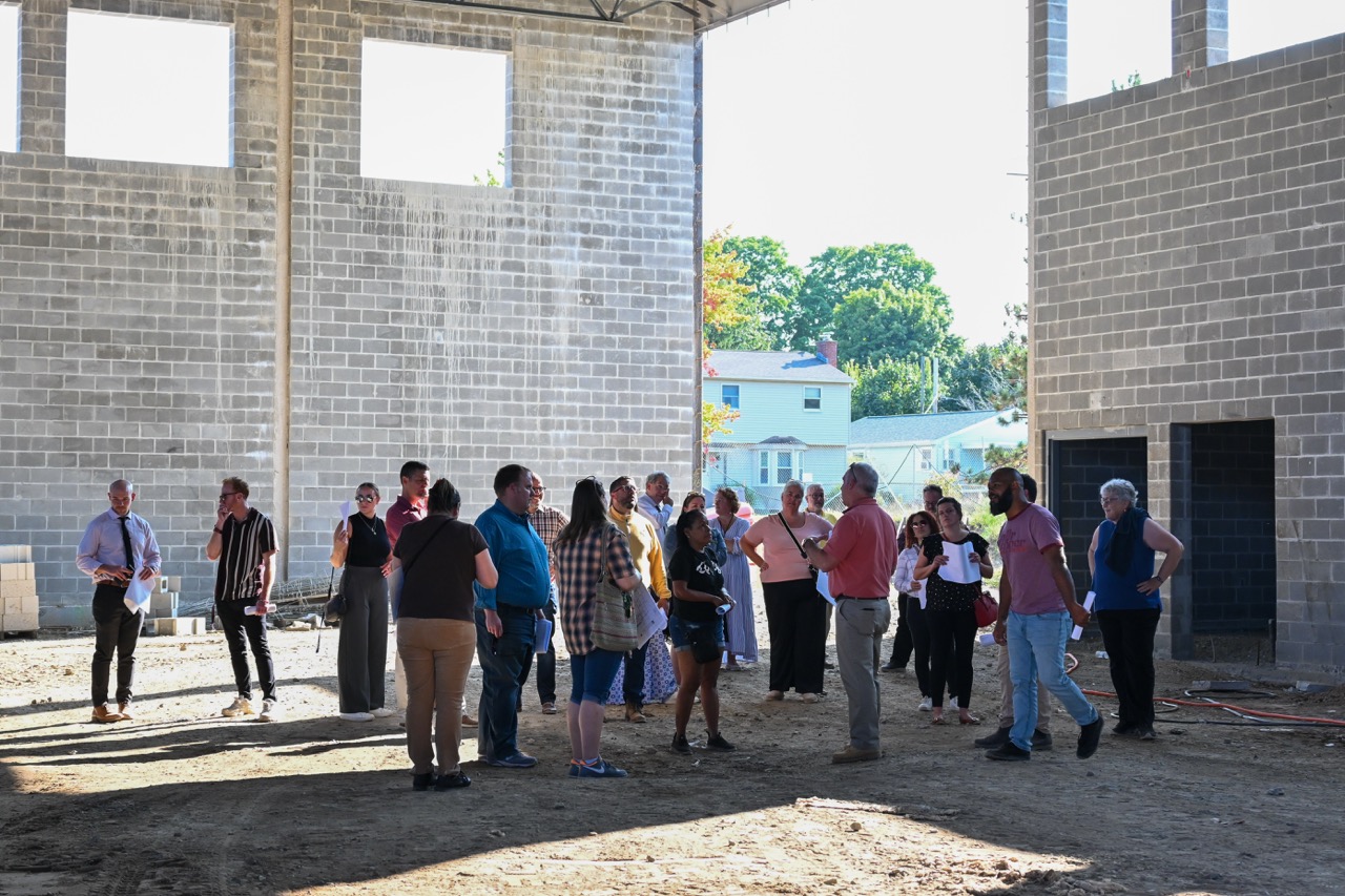 Group of school leaders inside the unfinished gynmasium