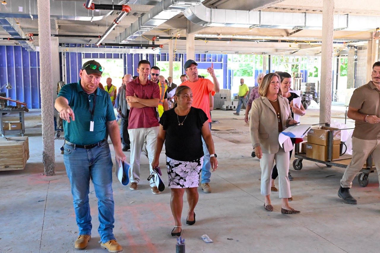 Leaders walk through the unfinished first floor 