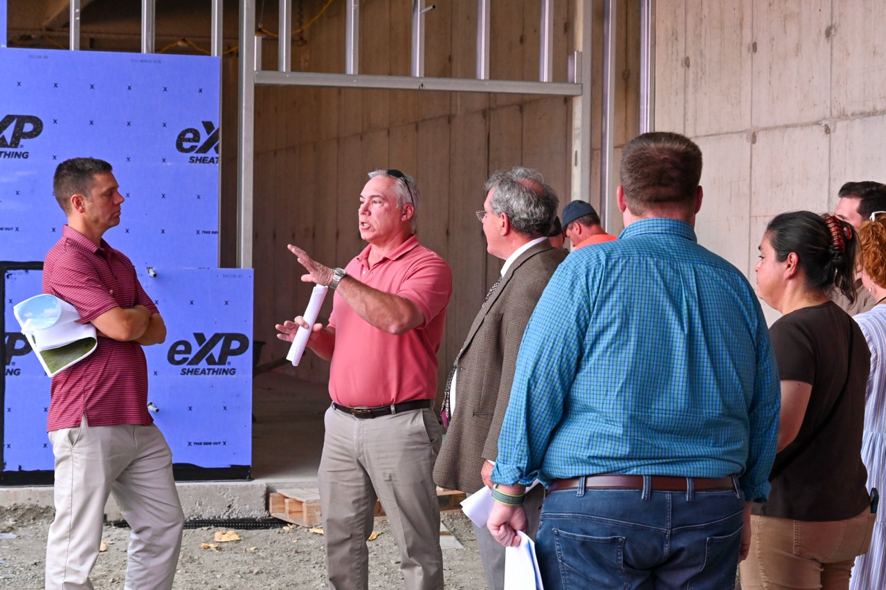 Project leaders speak to guests inside the building