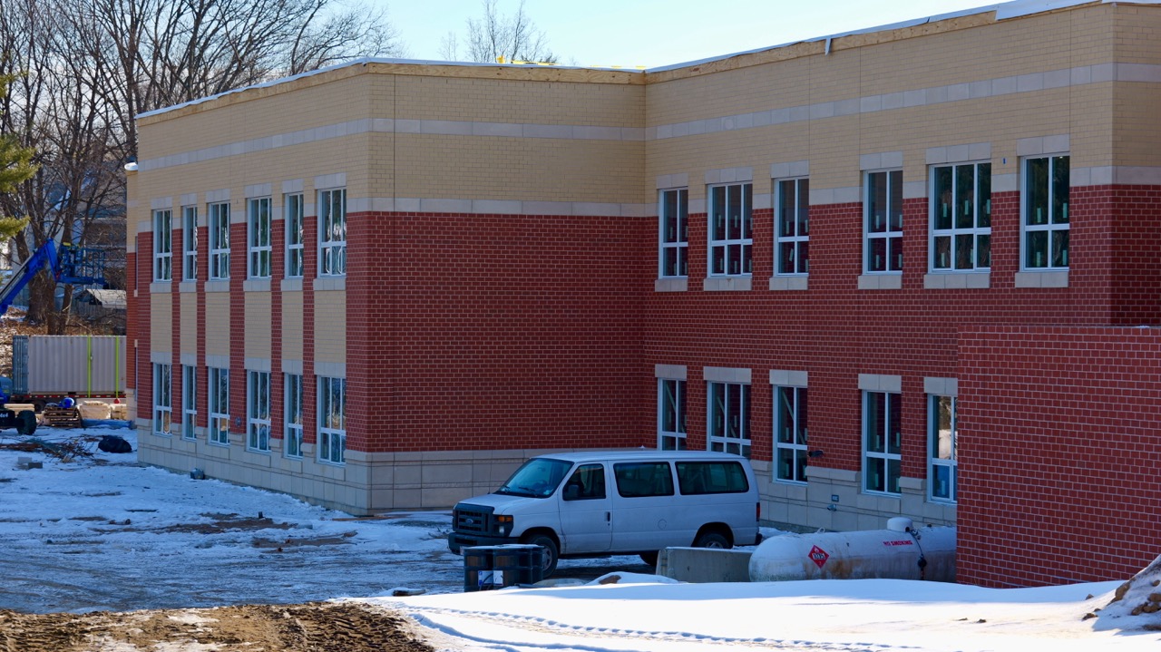 Exterior of the middle school with a van loading in equipment