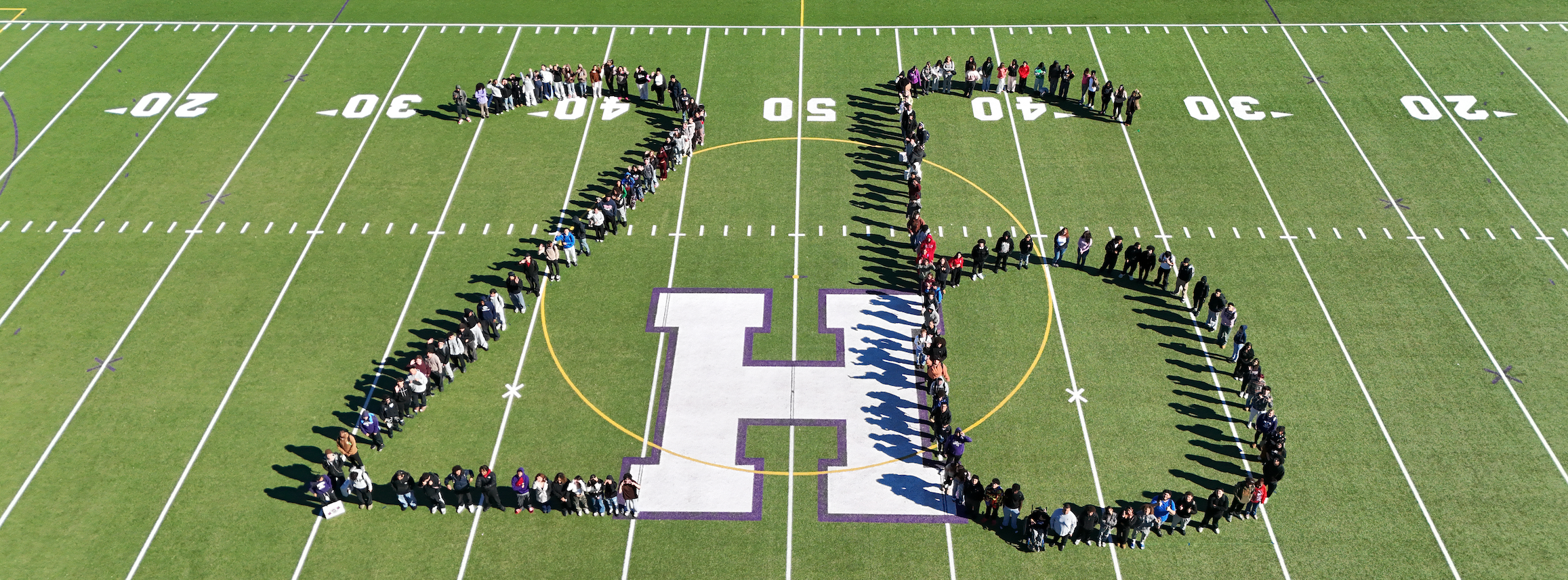 Students at HHS North spell out "26" on the field