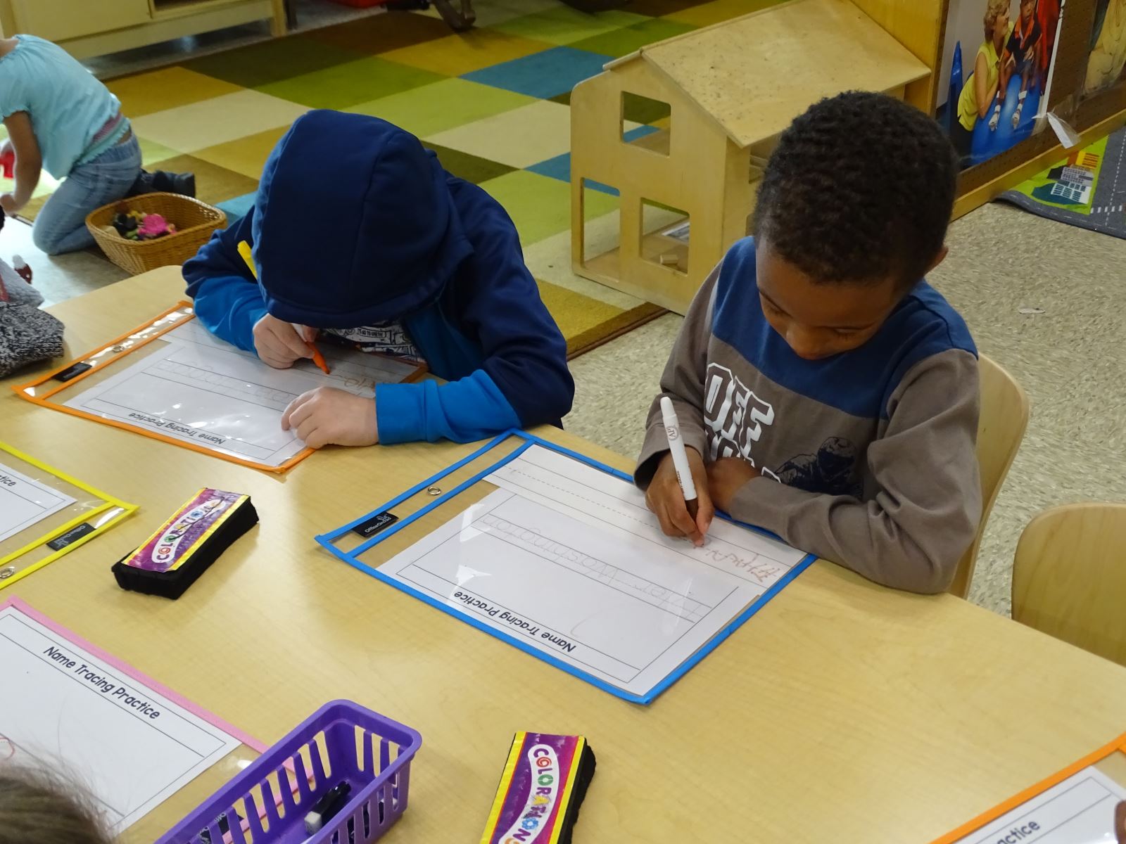 Preschool students working on letters