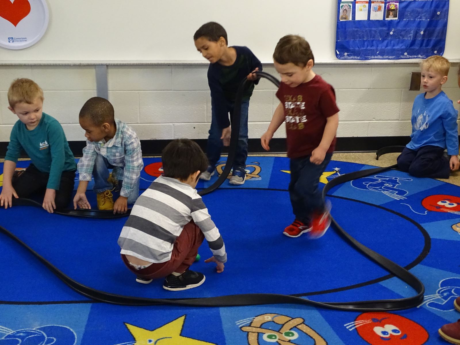 Preschool students playing in a center together