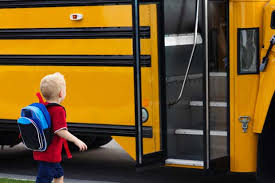 Child getting on bus