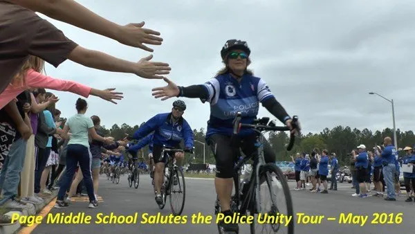 Woman riding bike for the Page Middle School Salutes the police Unity Tour - May 2016