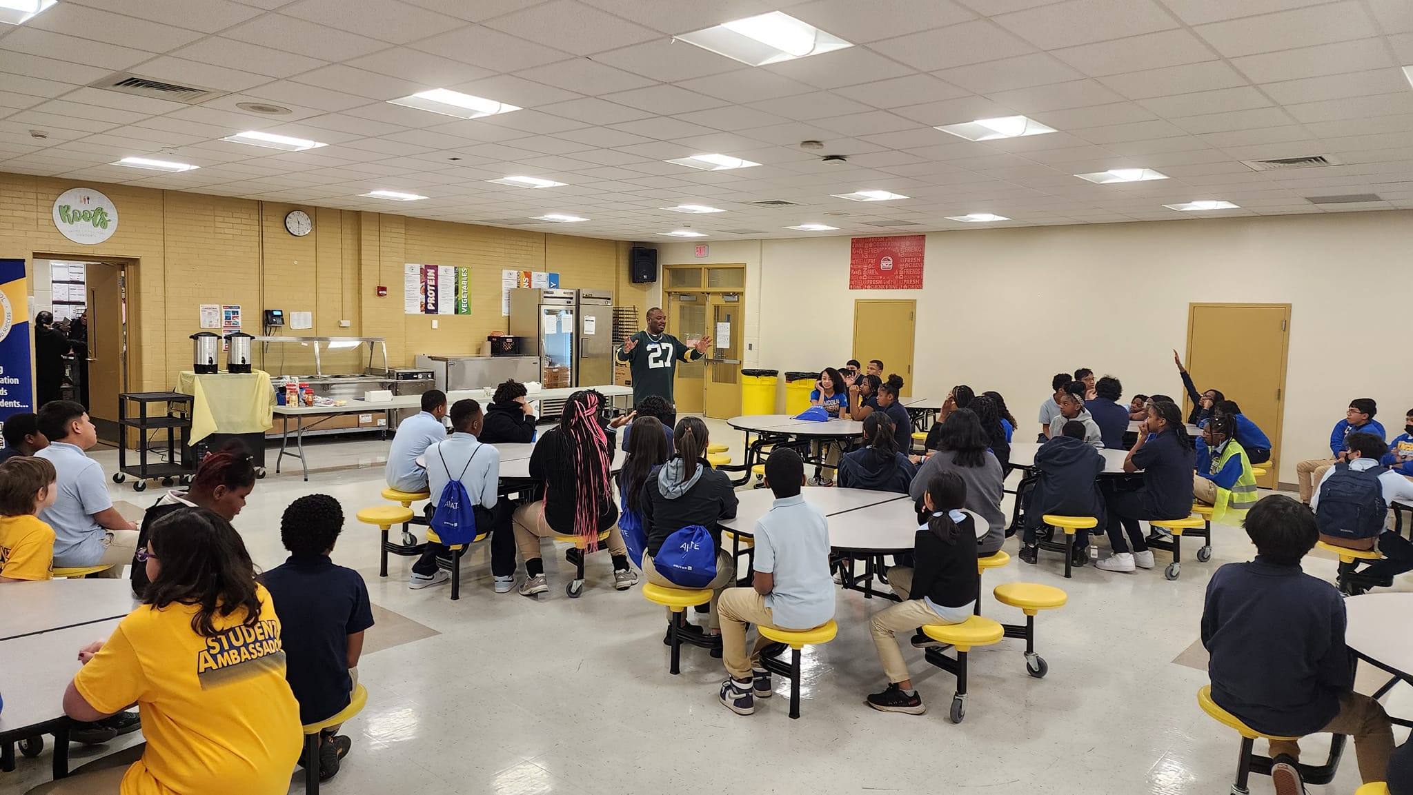 staff in cafeteria speaking to students
