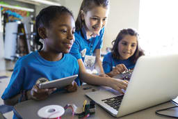 Students gathered around a laptop