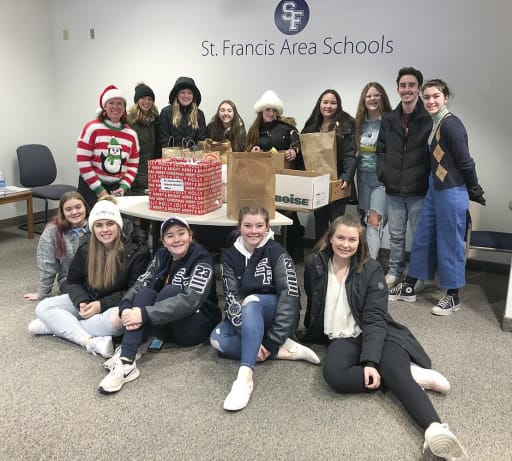 Superintendent Giese and students around donation boxes