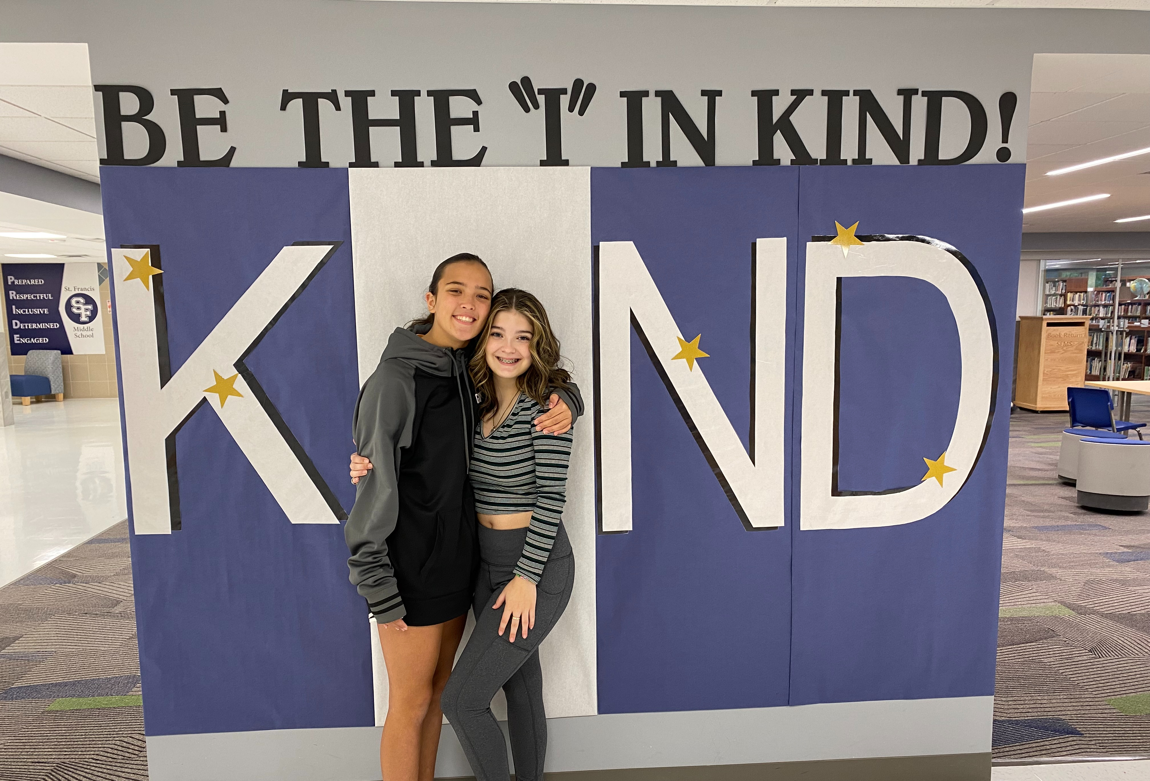 Image: Middle schoolers in front of the word kind