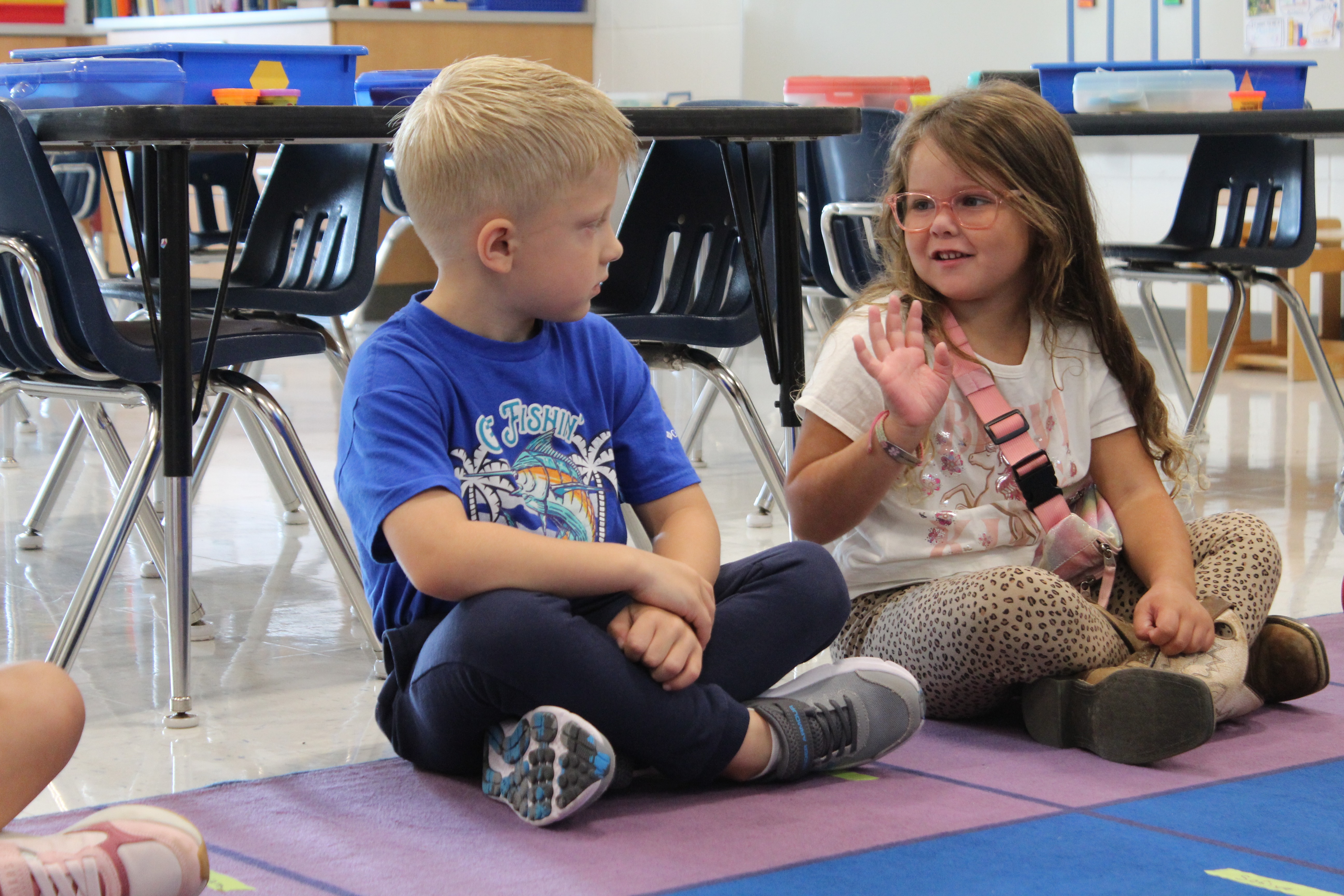 student waiving to another student