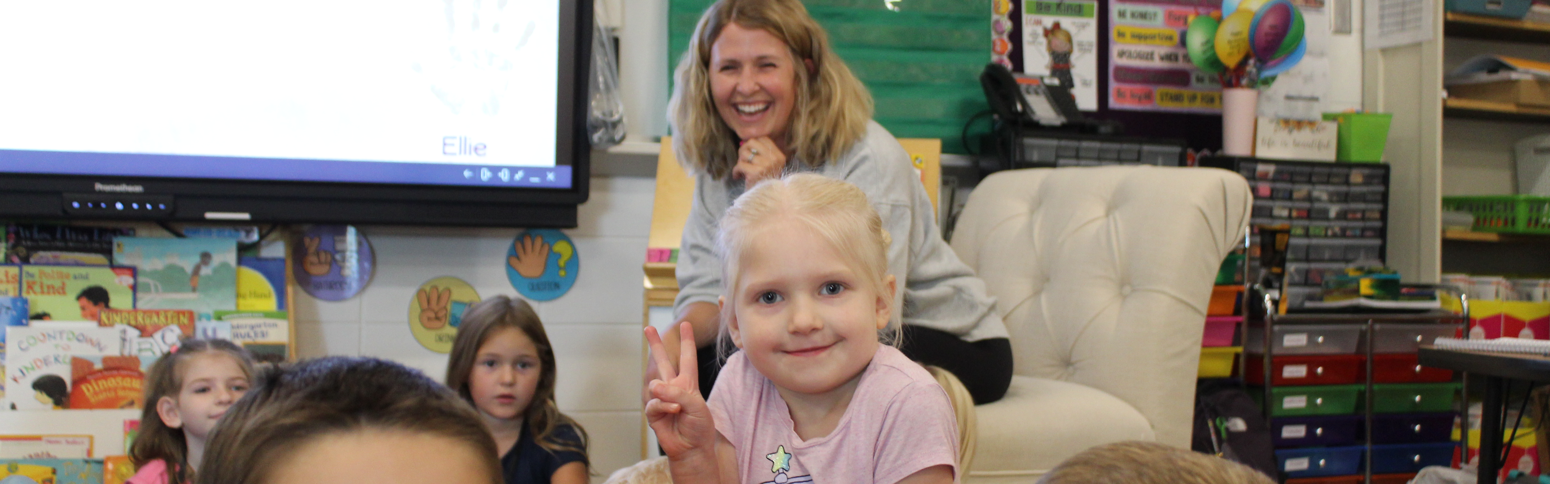 student giving peace sign