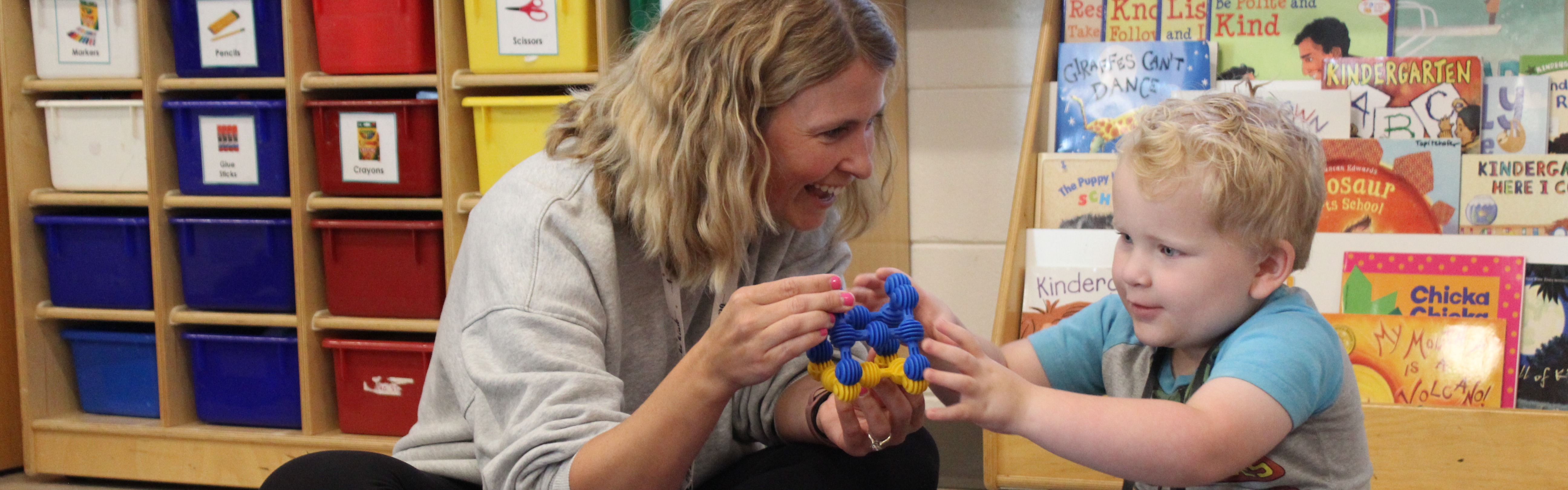kindergarten student with teacher
