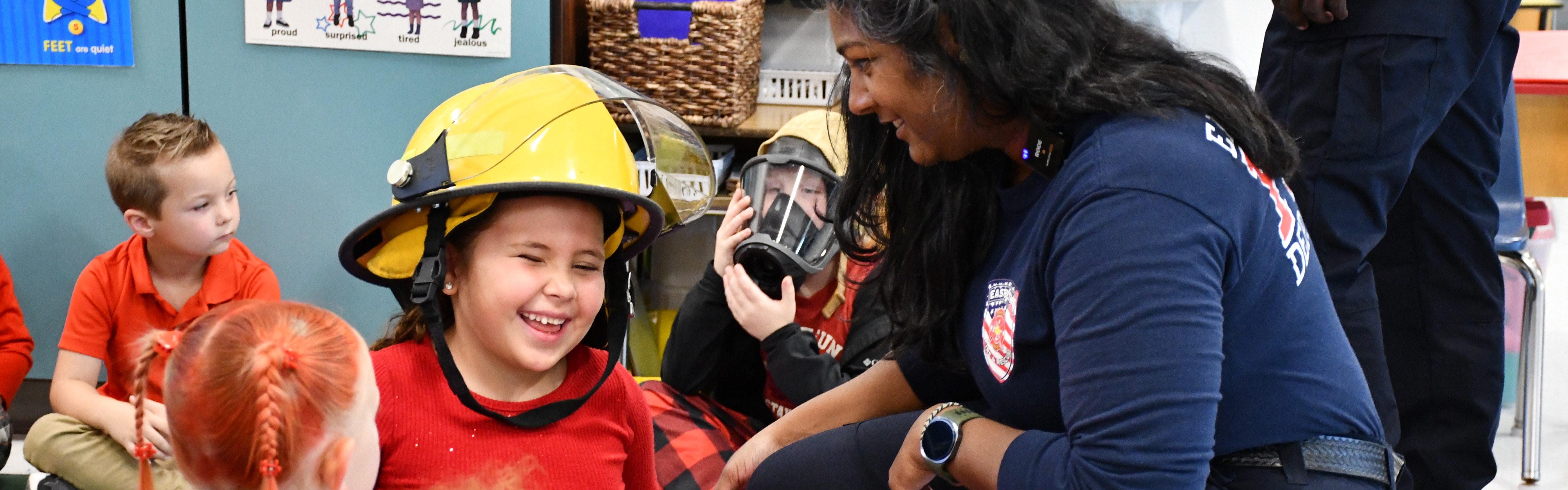 girl smiling with firefighter helmet on