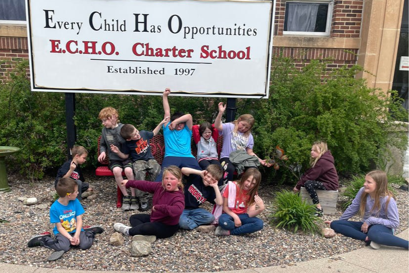 Students pose in front of ECHO sign