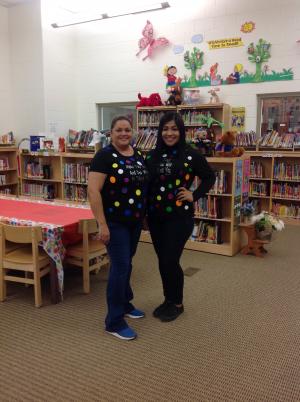 Two staff members in fun polka dotted shirts