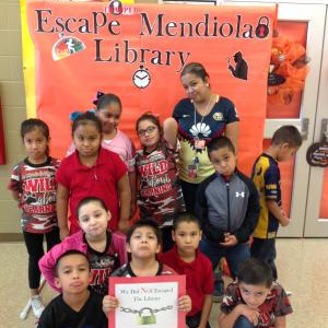A class holding a certificate saying "We escaped the Library"