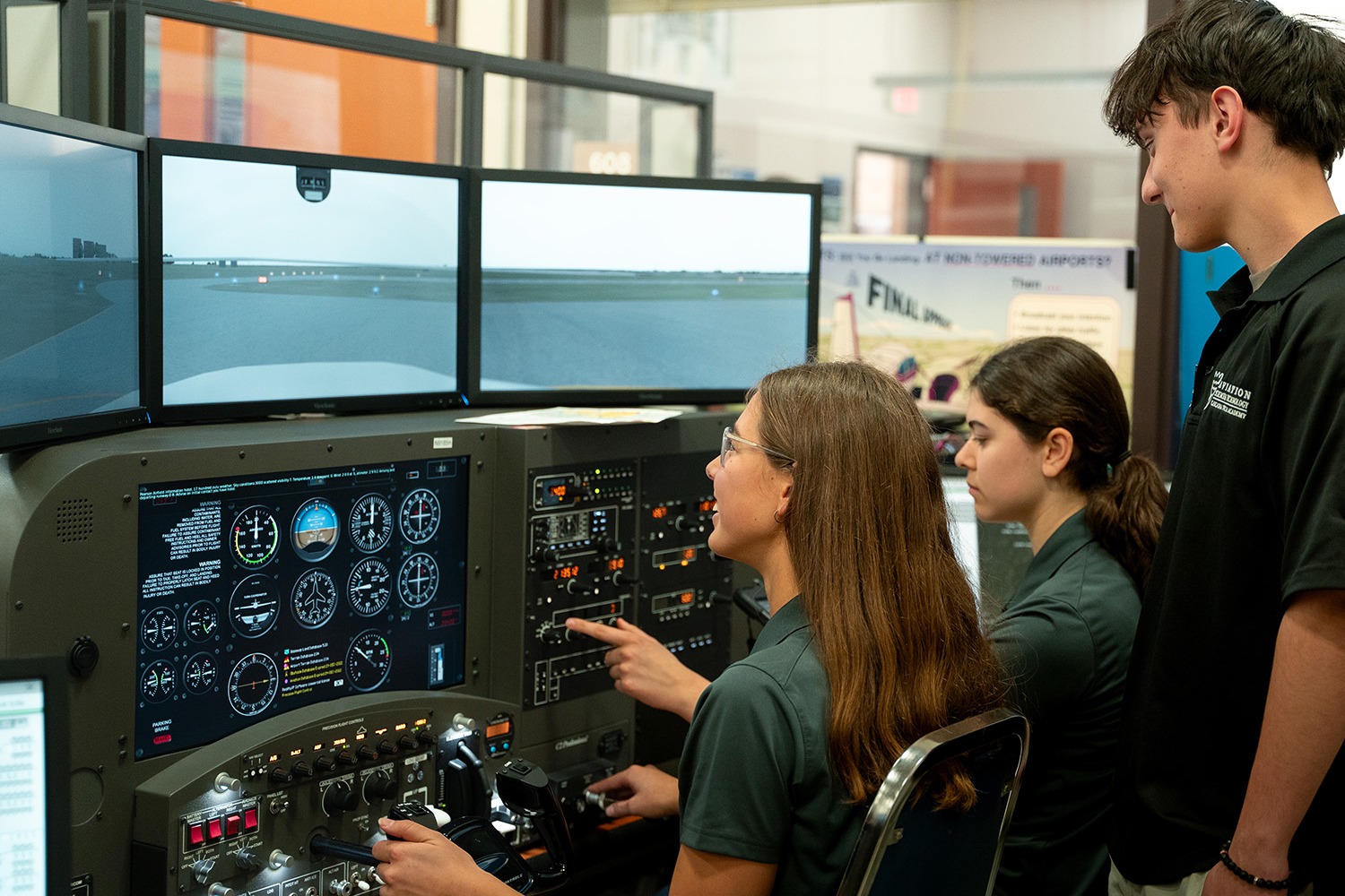 2 STUDENTS STANDING IN FRONT OF PLANE