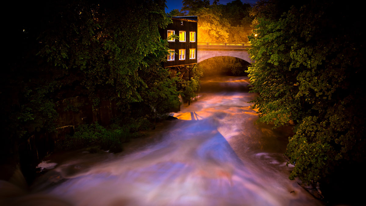 Eagle Creek flows past the historic watermill as it passes beneath the Windham Street Bridge