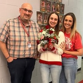 teacher of the year holding bouquet