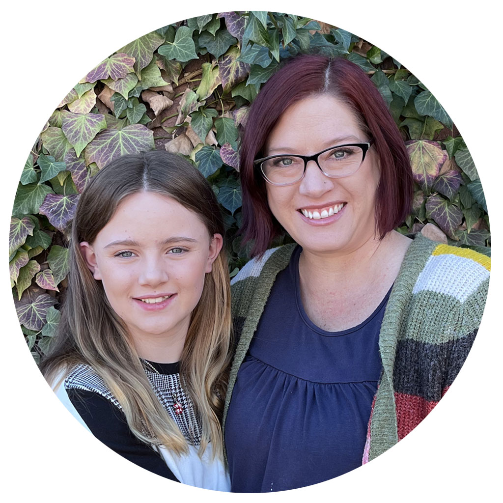 Middle School student with mother in front of ivy