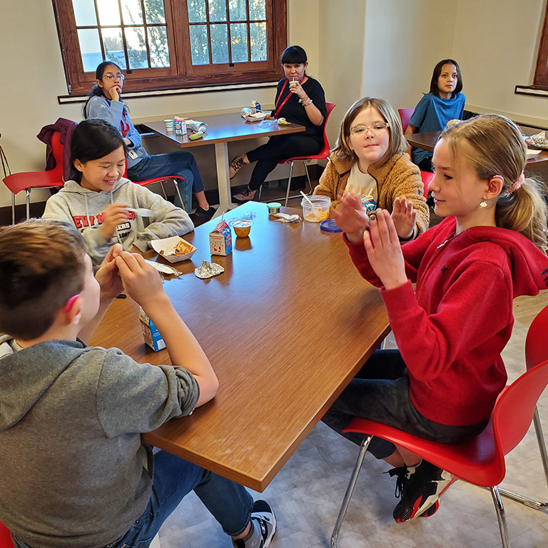 Students in the cafeteria eating lunch.