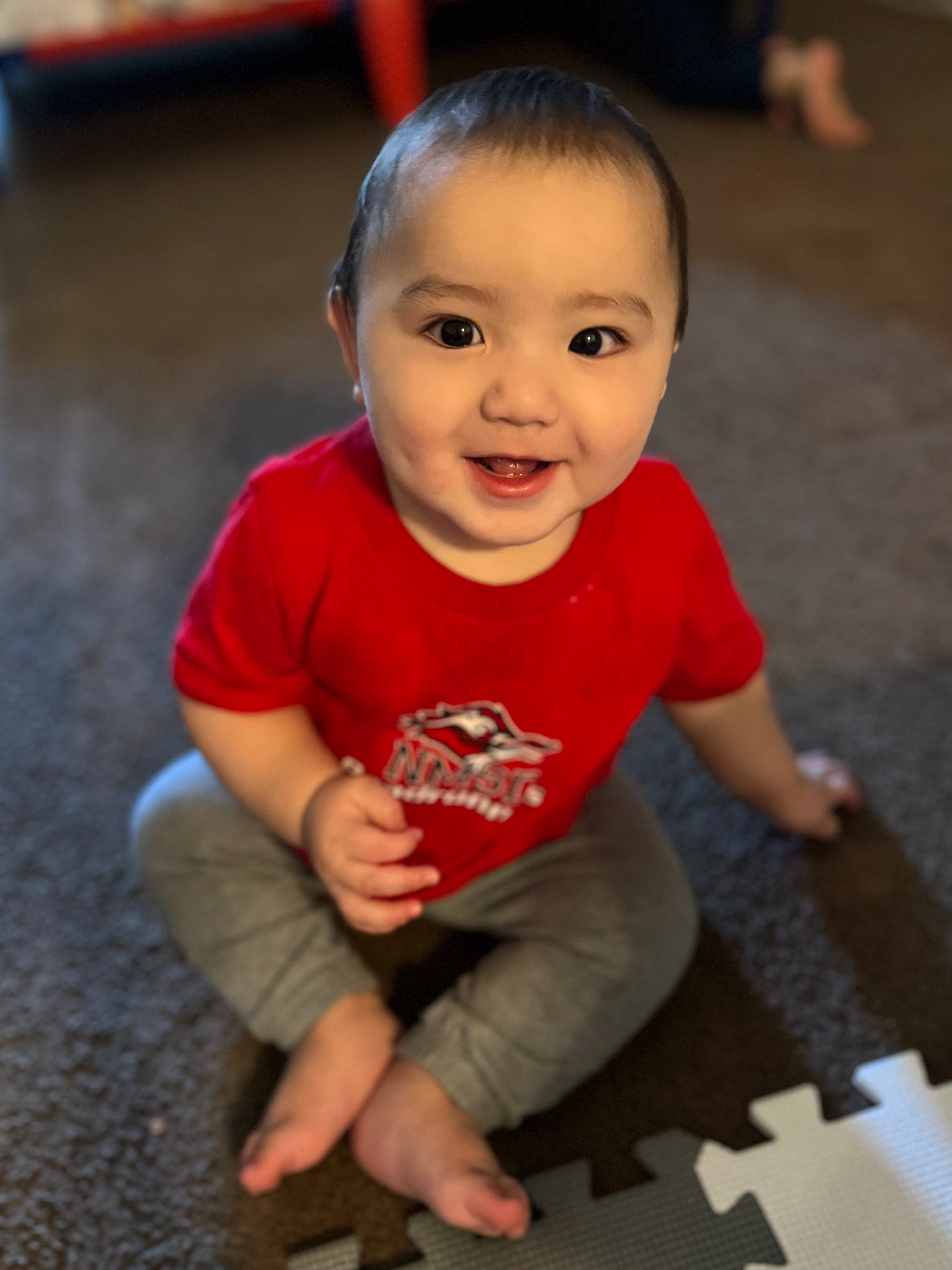Smiling baby wearing an NMSD t-shirt