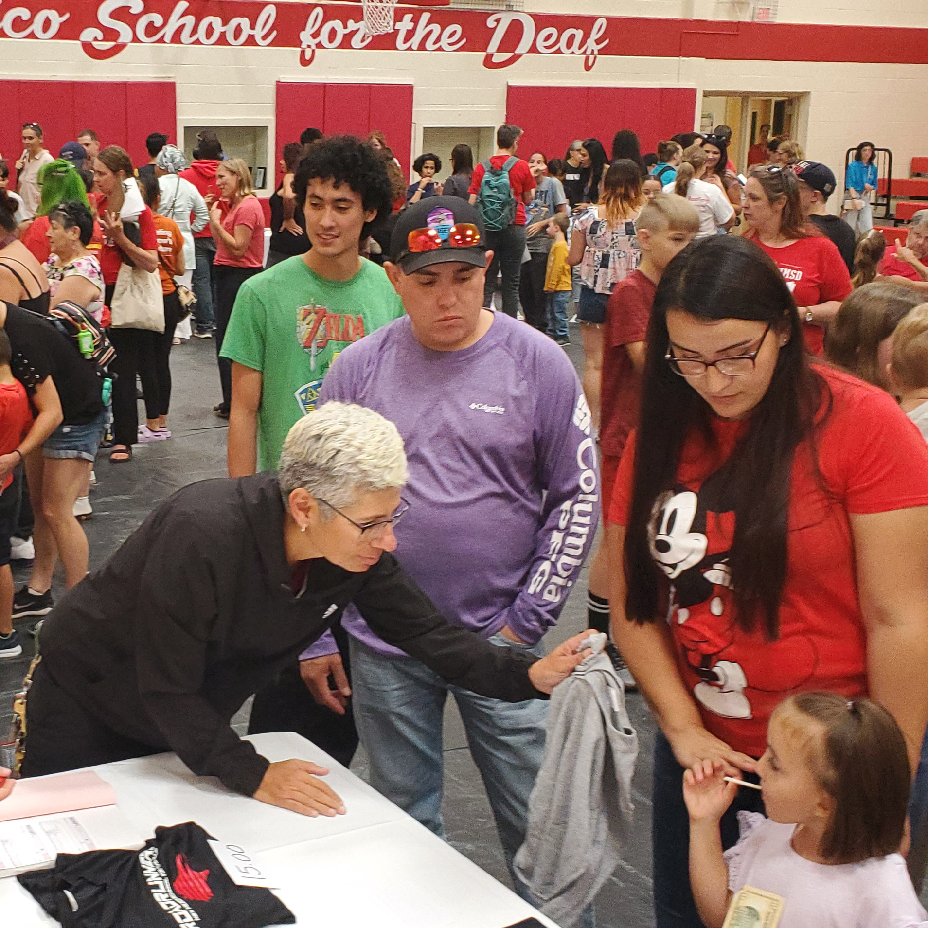 Group of students, staff, parent and interpreter at student registration