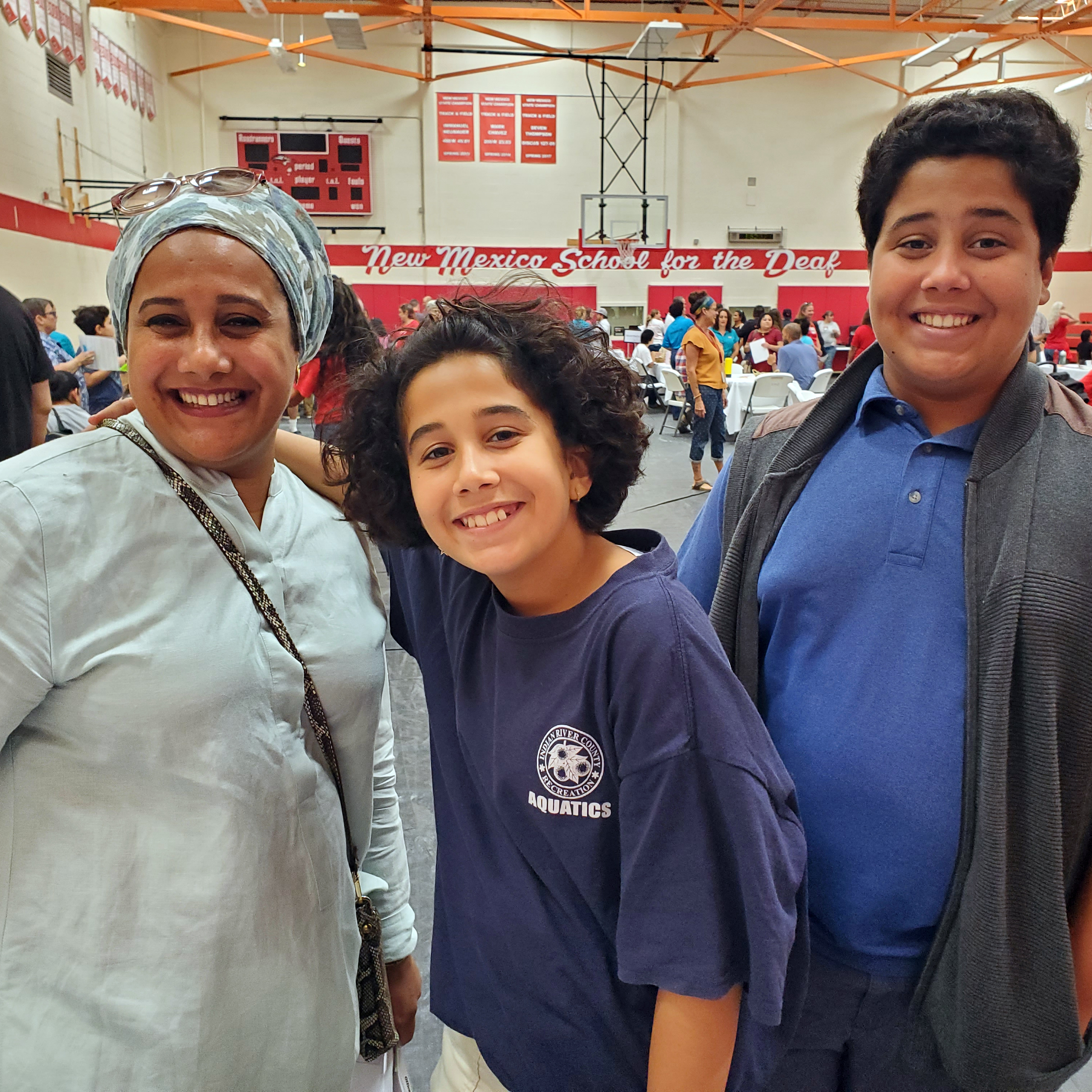 Middle-school student at registration with mother and brother