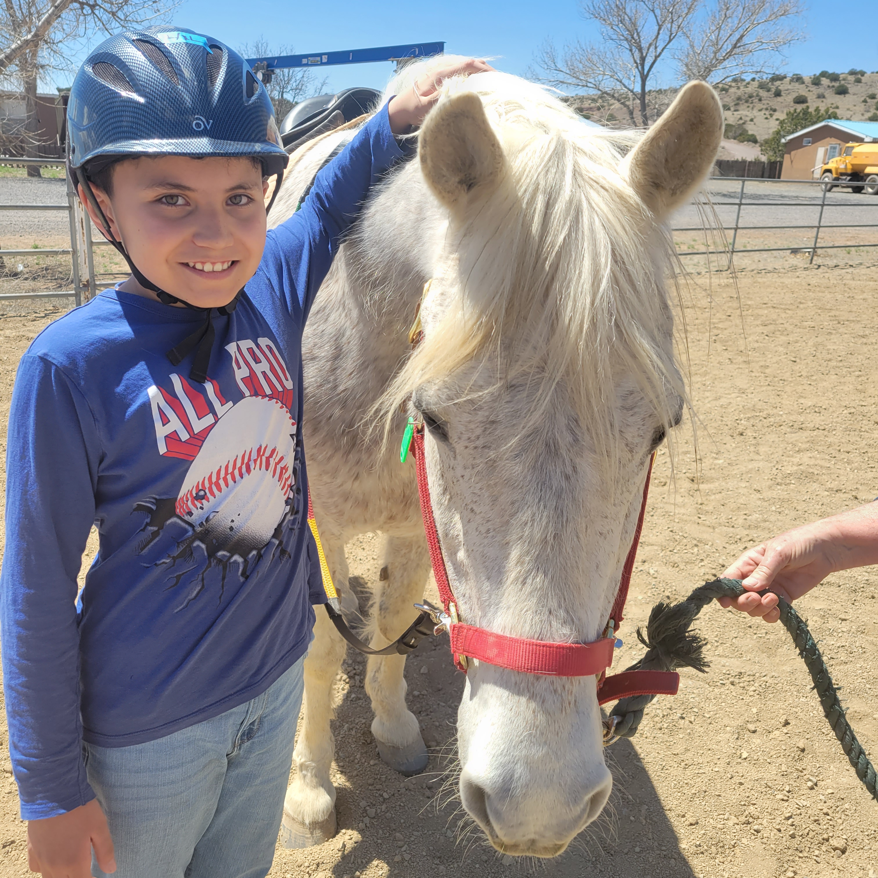 Elementary student  doing horse therapy