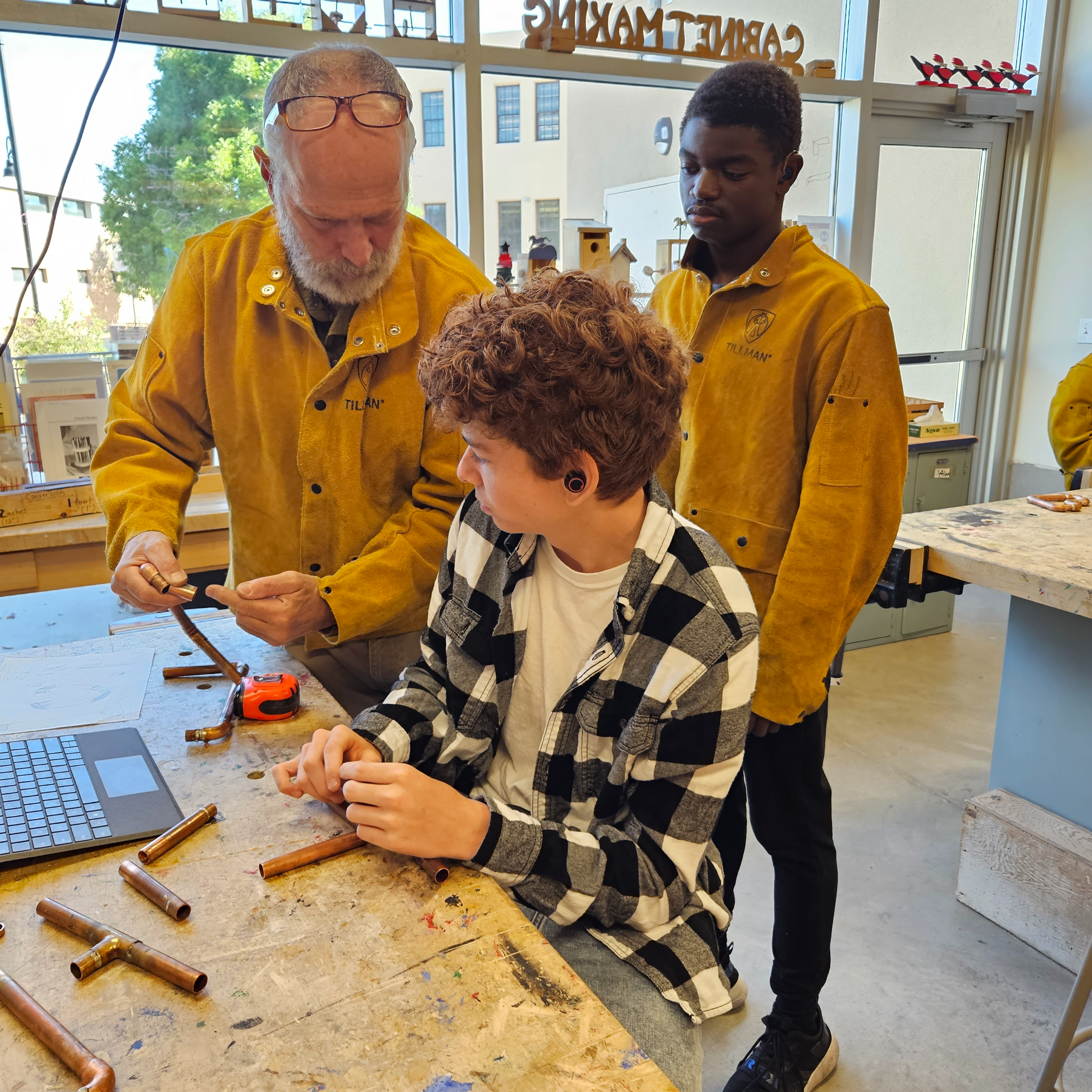 Teacher and two students in wood shop class