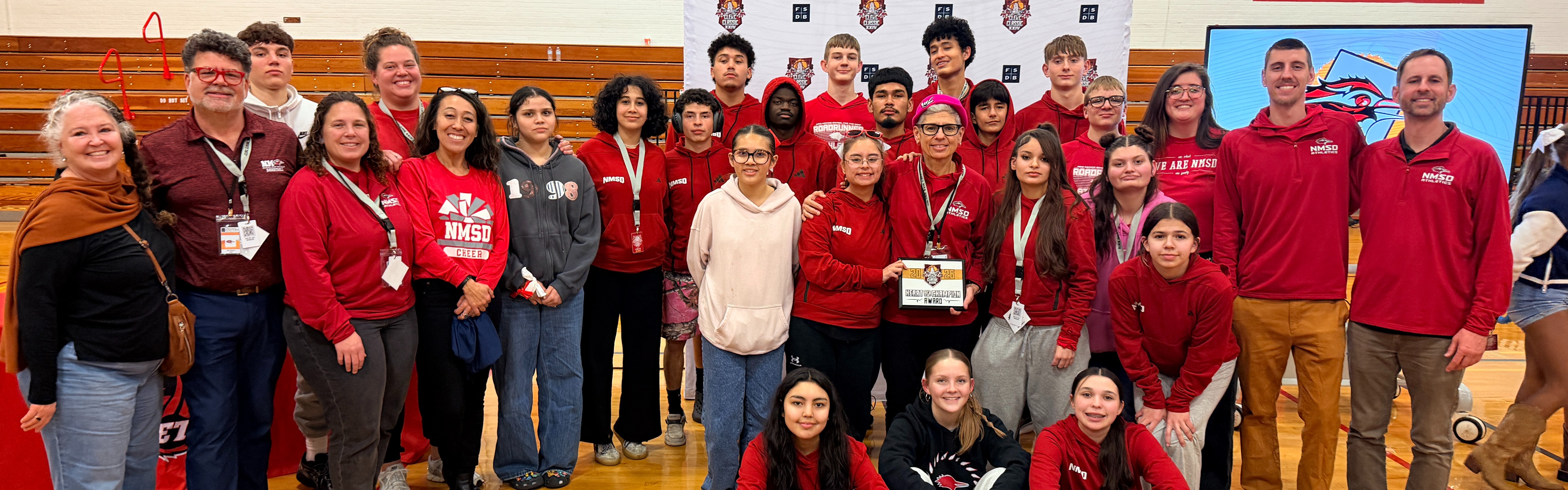Group of students, staff and family showing NMSD pride.