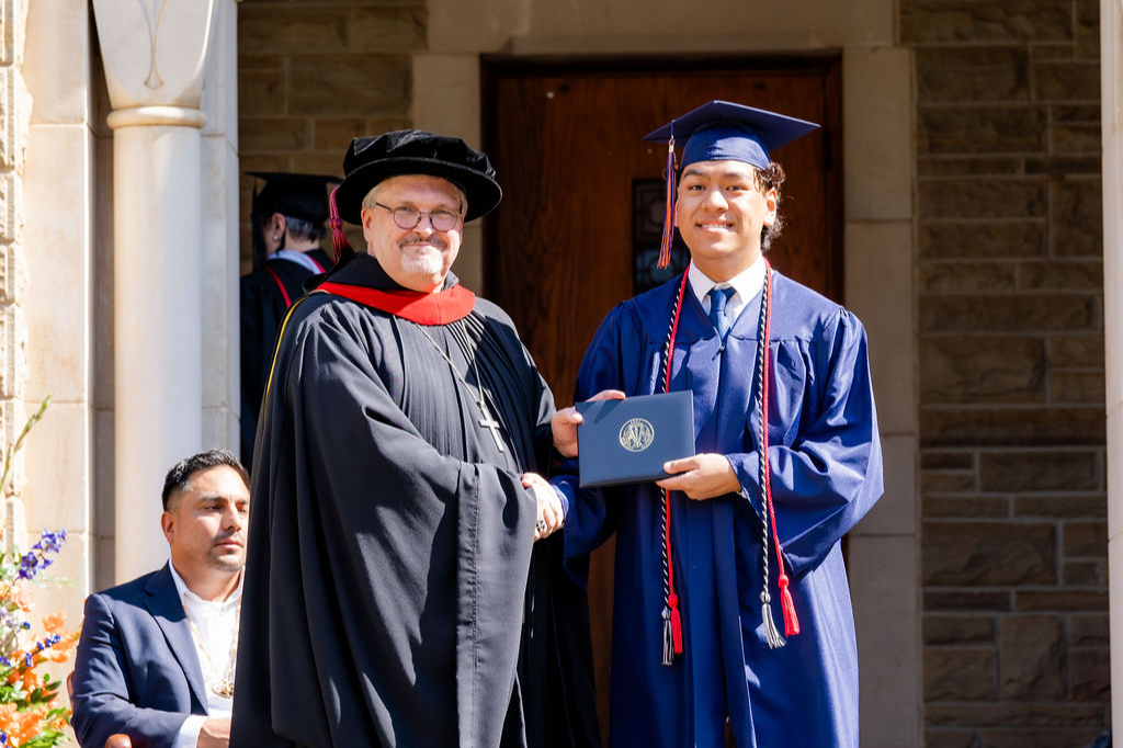 student at graduation with abbot elijah