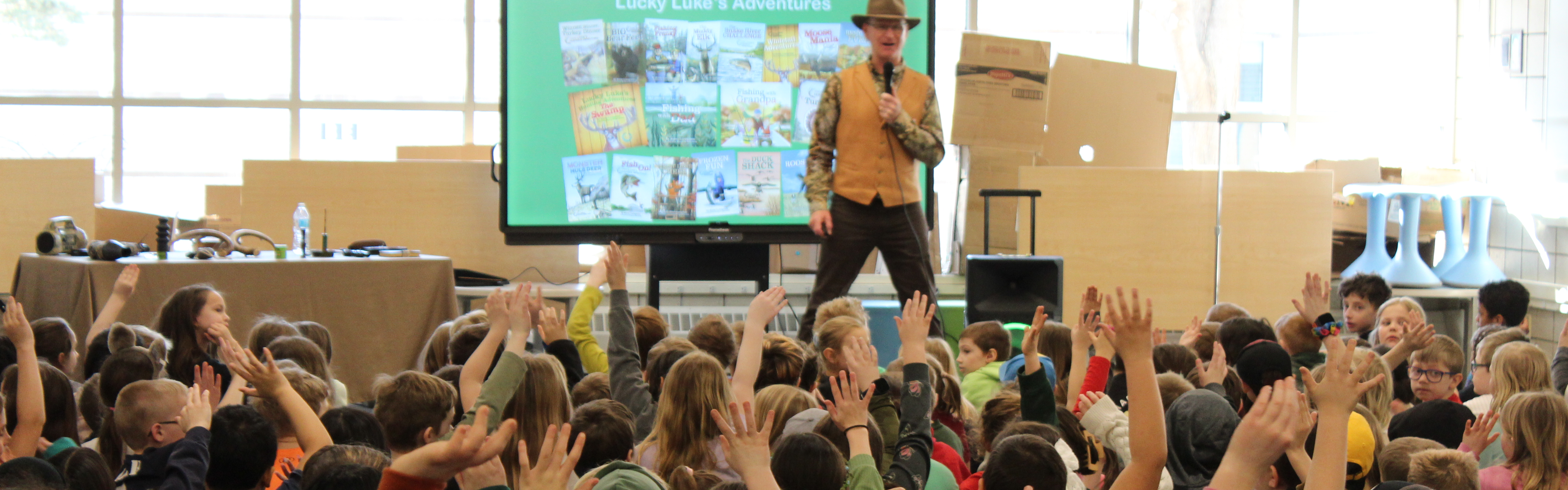 kids raising hands to presenter