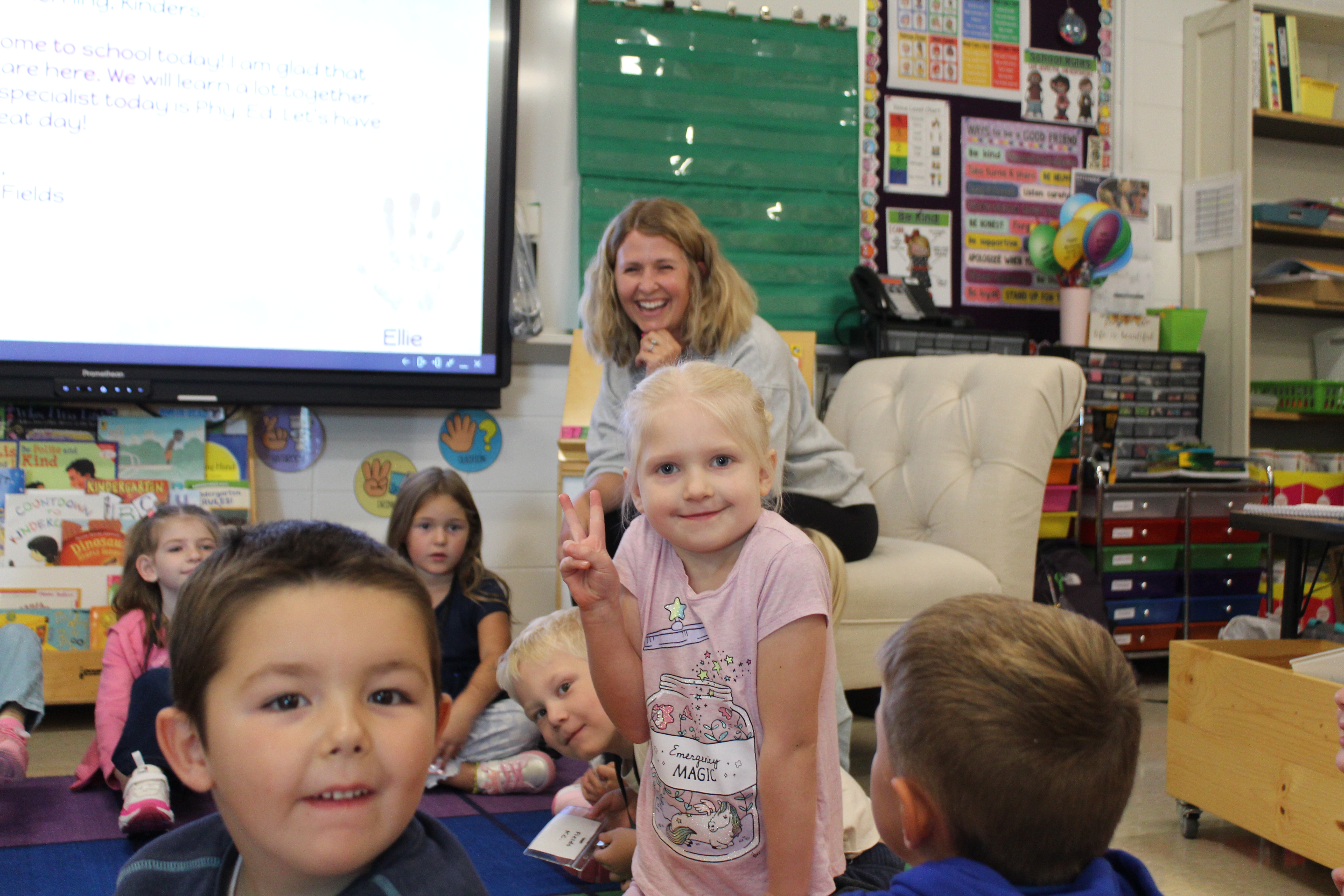 kindergarten student giving peace sign