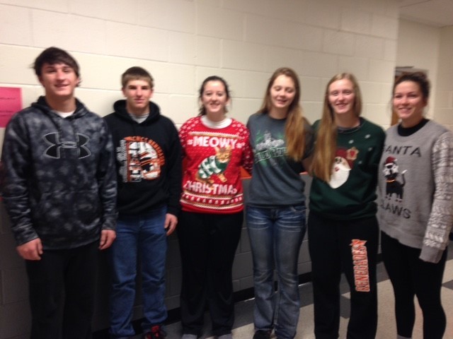 A photo of NHS members in the school hallway, some are wearing Christmas sweaters