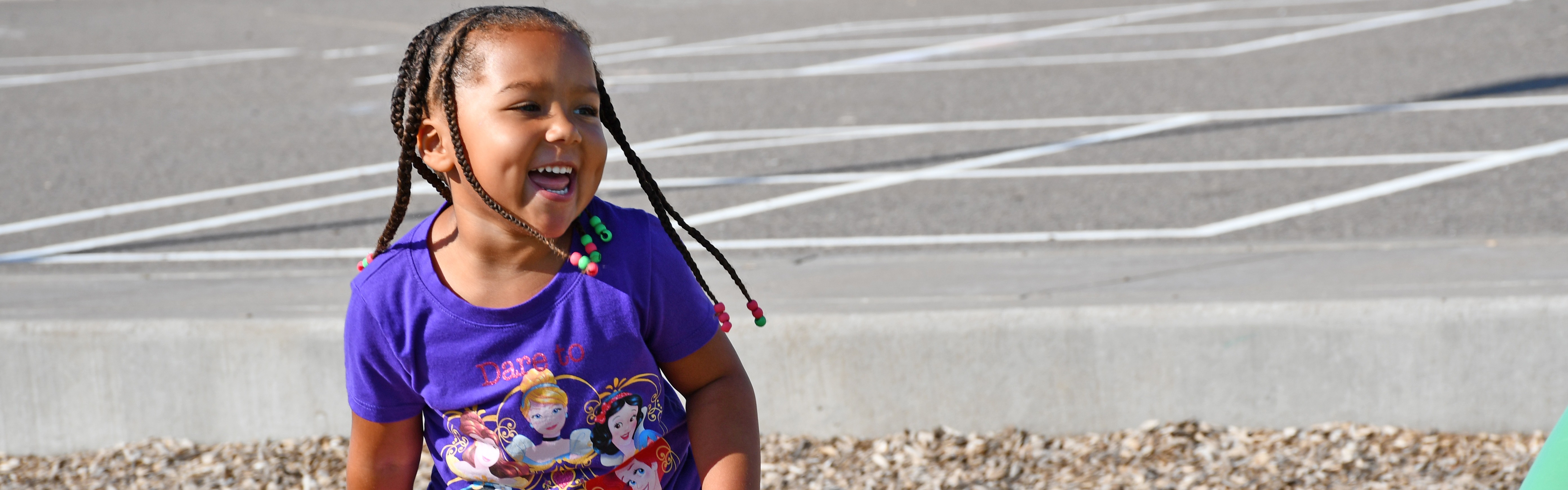 girl on playground smiling