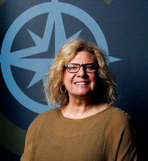 headshot of Randi Richards Lutz next to American Flad in front of CTEC logo on the wall 