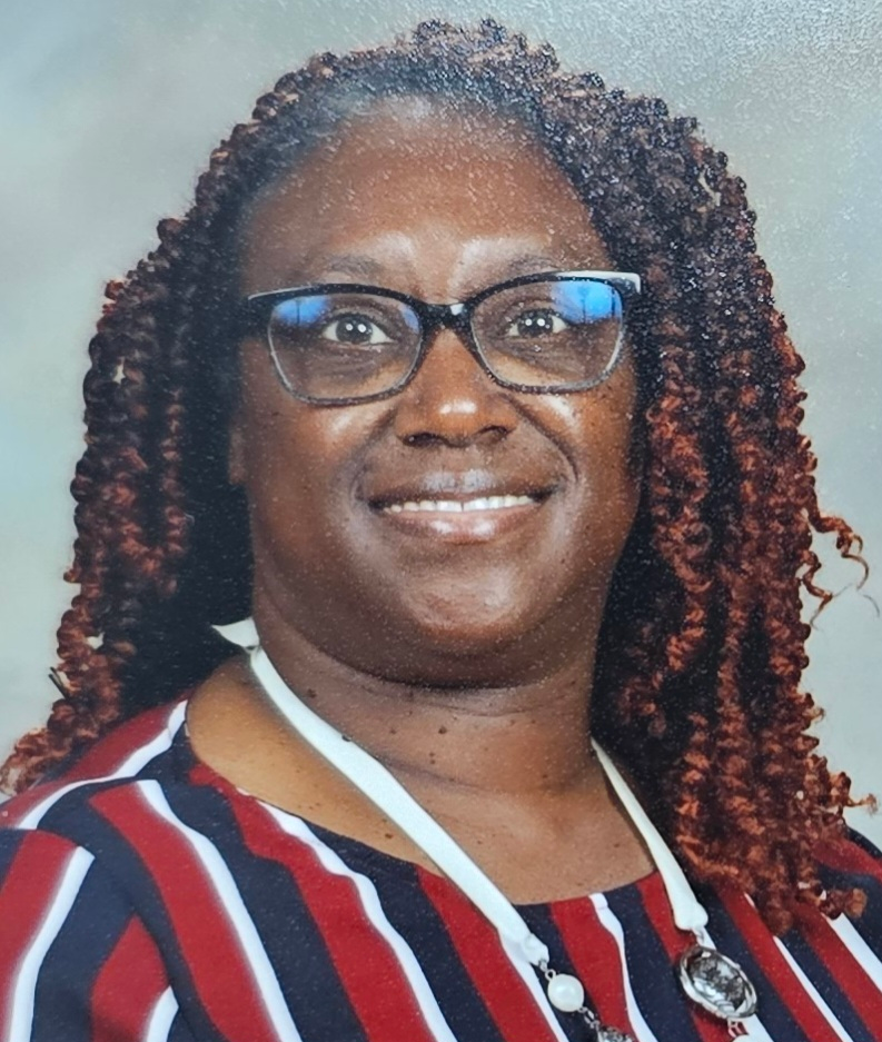Shawana Cash in a purple shirt smiling
