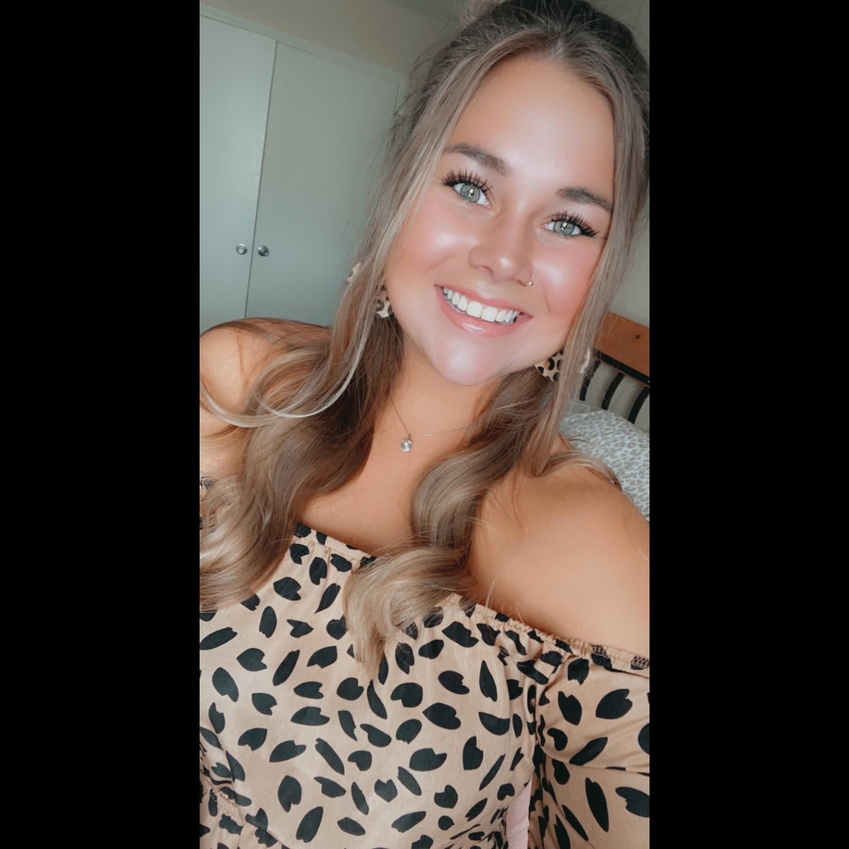 Smiling woman wearing animal print top