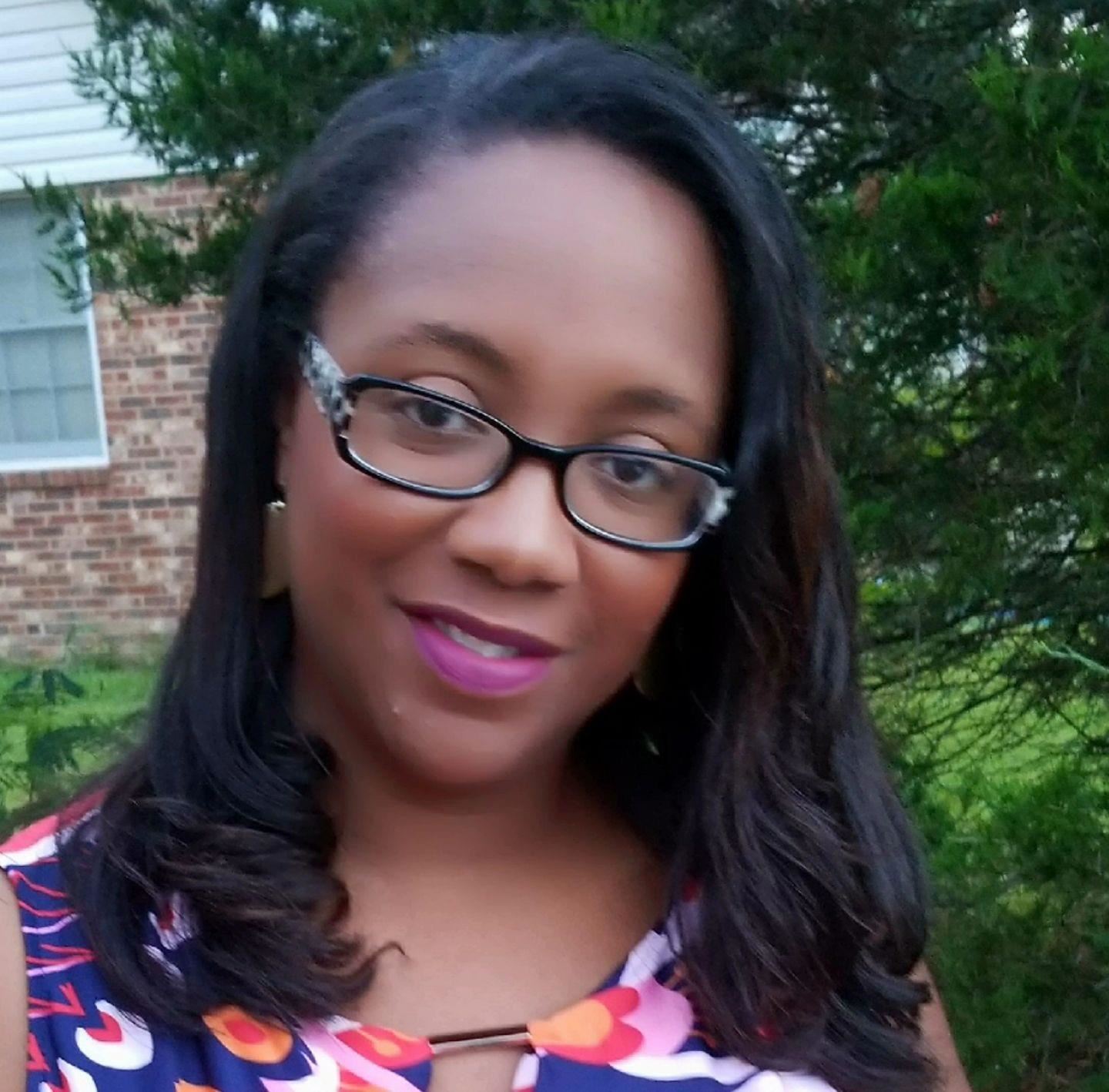 Smiling woman wearing glasses in front of natural background