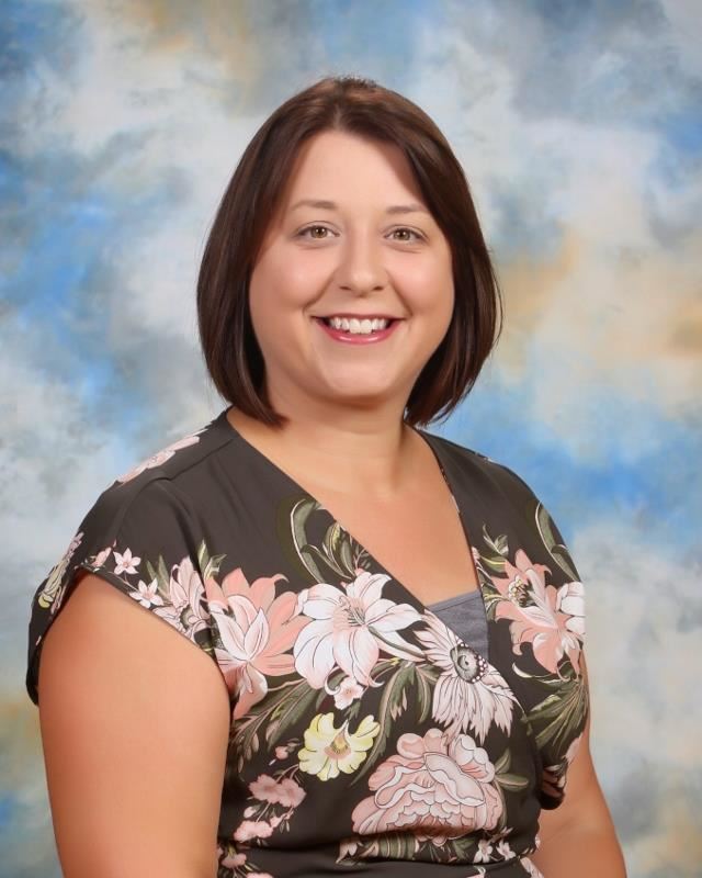 Smiling woman in front of blue sky background